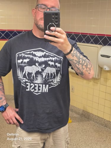 Customer's black Meese T-shirt with white graphic in a mirror selfie
