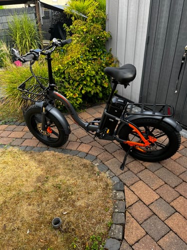 Customer's Vakole Y20 Pro foldable e-bike with fat tires parked on a paved patio.