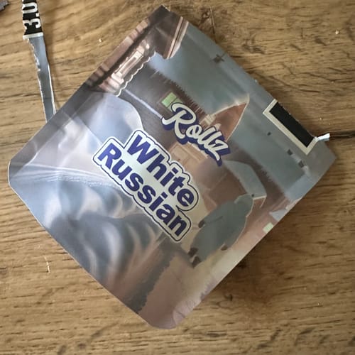 Customer's Rollz White Russian packaging on a wooden surface.