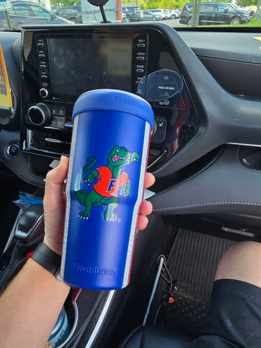 Customer's Florida Gators To-Go Buddy tumbler held in a hand inside a car.