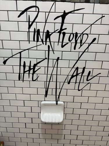 Customer's black Pink Floyd The Wall decal applied to a white subway tile wall above a soap dish.