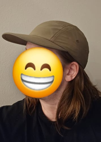 Customer's Big Camp Hat Ripstop in tan worn on head, showing the five panel style and bound bill.