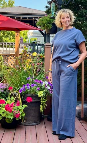Customer's Zen Ribbed Lounge Set in denim blue, featuring a relaxed wide-leg fit, worn while standing outdoors.