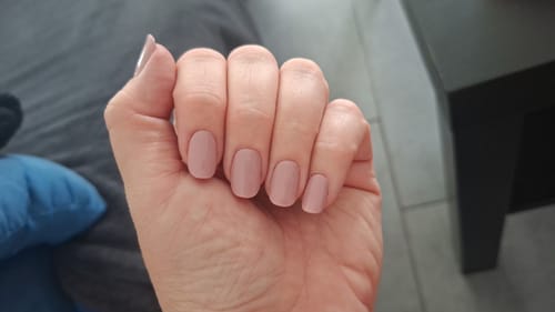 Customer's hand showcasing the Vintage Roses UV Gel Nail Wraps with a smooth, dark rosé finish.
