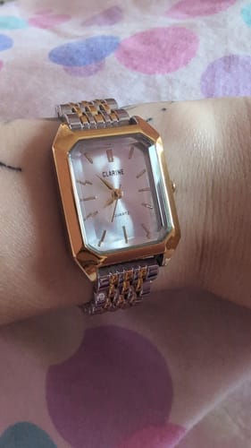 Customer's silver and gold-tone Claire De Mains watch worn on a wrist, featuring a rectangular face.