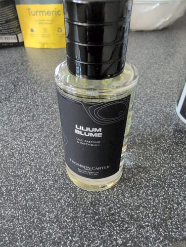 Customer's Lilium Blume eau de parfum bottle with black label on a grey surface.
