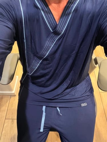 Customer's navy blue Himoriwabi Kaizen Samue pajamas worn in a seated position.