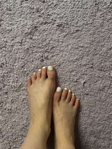 Kunden-Foto von Füßen mit UV Nagellack No. 44 in hellem Farbton auf einem beigen Teppich.