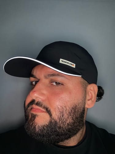 Customer's Big Running Hat in black with a white-trimmed bill, worn by the reviewer.