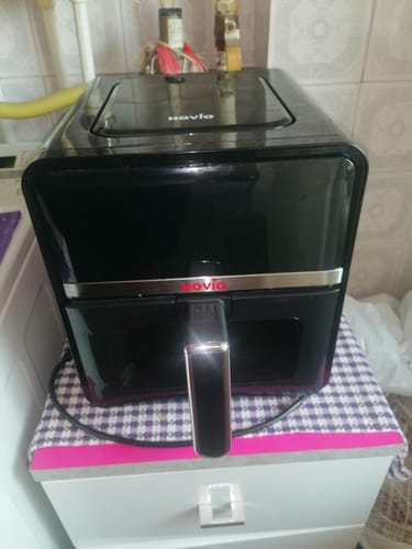 Customer's Novio StonePro air fryer, a sleek black countertop appliance, resting on a small kitchen cabinet.