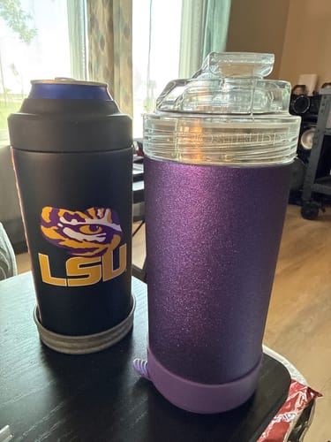 Customer's Universal XL LSU Tigers cooler with a can next to a purple glittery Universal XL cooler on a table.
