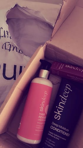 Customer's Hair Revival Set in a box, showing a pink shampoo bottle and a dark blue conditioner tube.