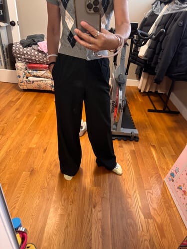 Reviewer's black wide leg casual sweatpants, styled with a sweater.