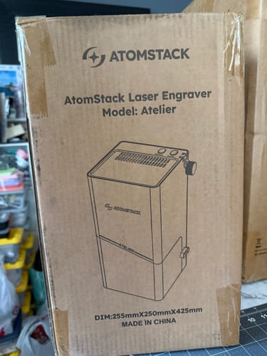 Customer's cardboard box containing an AtomStack laser engraver, Atelier model, delivered safely.