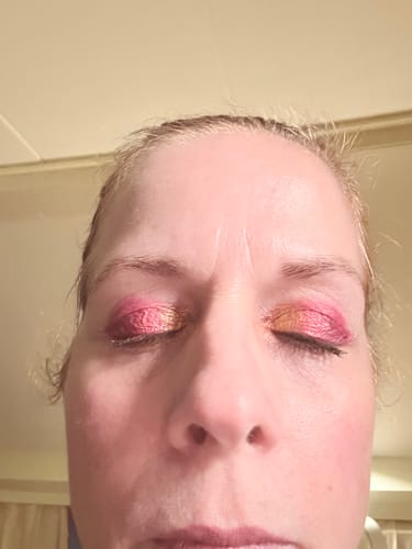 Customer's eyes closed, wearing vibrant pink and gold eyeshadow from the Creative Comeback Palette.
