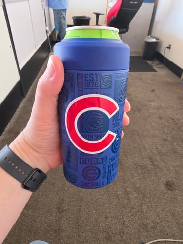 Customer's blue Chicago Cubs Frost Buddy can cooler held in hand, showing the team logo.