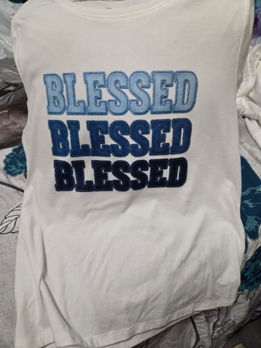 Customer's white t-shirt featuring the word BLESSED printed in three descending shades of blue.