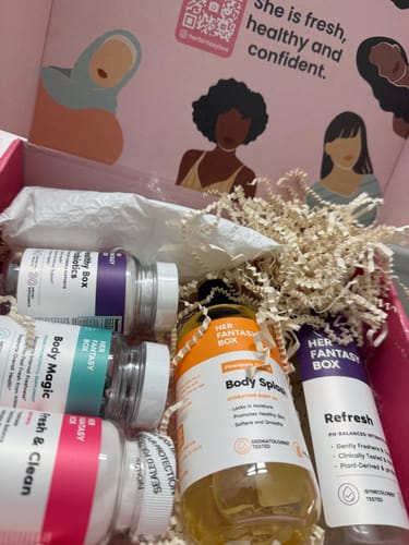 Customer's Ultimate Glow-Up Kit, showcasing bottles of supplements, cleansers, and body oils nestled in a gift box.