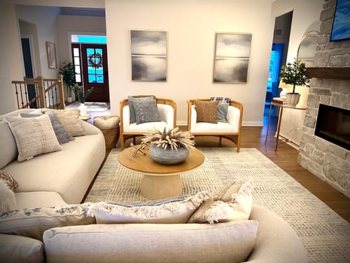 Customer's Still Horizon Set of 2 wall art prints displayed in a bright, modern living room.