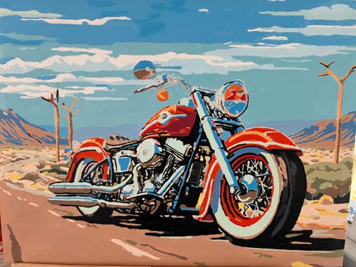 Reviewer's Vintage Motorcycle Majesty painting of a red motorcycle parked in a scenic desert landscape.