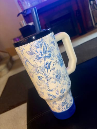 Customer's floral Bumper Buddy on a tumbler with a blue straw and navy lid.