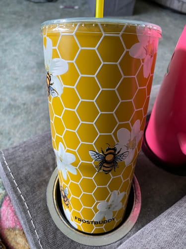 Customer's yellow Bee Kind To-Go Buddy tumbler with honeycombs and bee patterns, sitting in a cup holder.