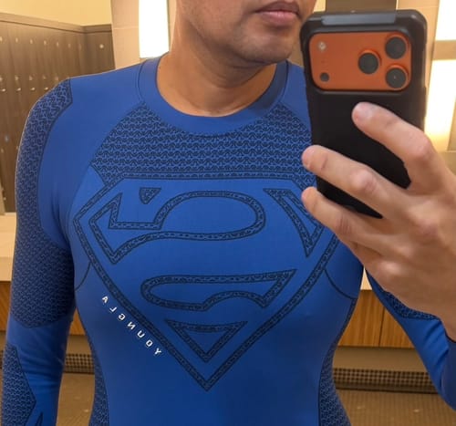 Customer's blue Superman Compression Longsleeves, showing the bold chest graphic while taking a mirror selfie.
