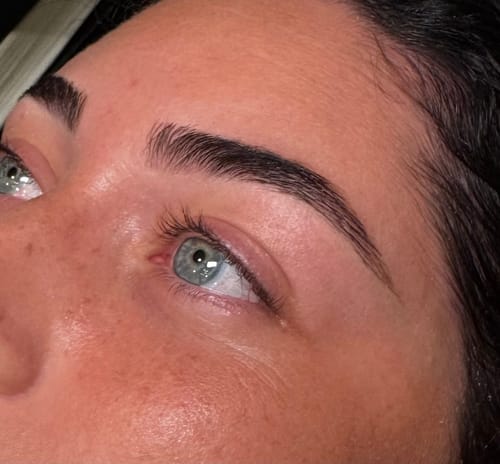 Customer's well-defined, dark groomed eyebrows after using the Hybrid Stain and Eyebrow Lamination treatment.