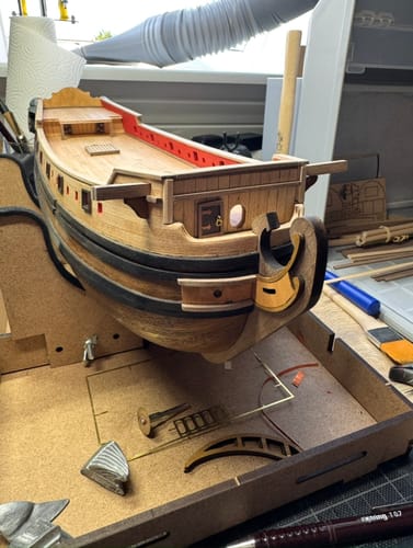 Customer's wooden Maqueta Barco La Candelaria model with detailed deck components on a workstation.