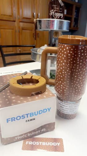 Customer's Fawn Thicc Buddy 40oz mug, lid, and packaging box displayed on a table.