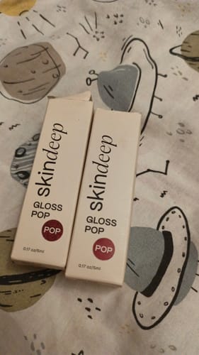 Customer's two Gloss POP boxes sitting on a patterned surface.