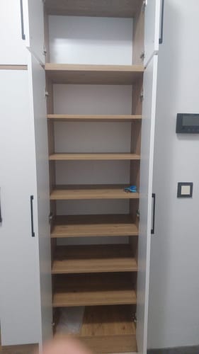 Customer's Rani Modern Portmanto open, showing internal wooden shelves and a white frame in a residential interior.