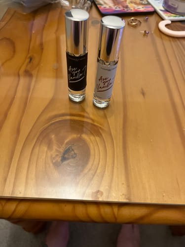 Customer's Are You Vanilla Night and Day eau de parfum roll-on bottles sitting on a wooden surface.