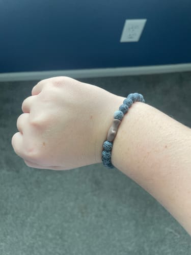 Customer's gray Voyage Bracelet with textured beads worn on their wrist