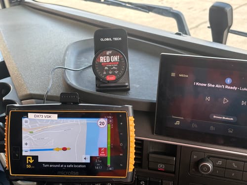 Customer's Red On! Caffeine Pouch tin sitting on a phone stand in a truck cab.