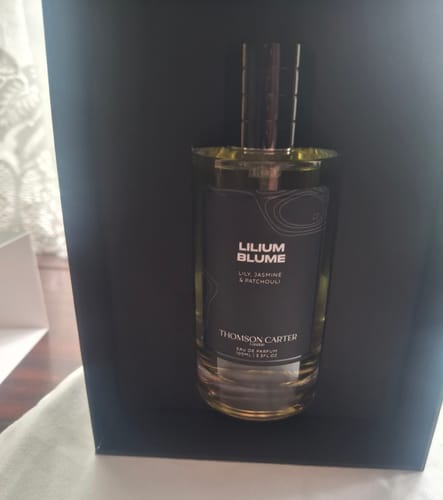 Customer's Lilium Blume perfume bottle centered inside a dark, open presentation box.