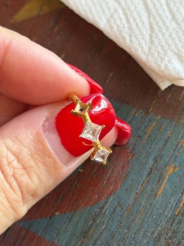 Customer's gold Orion's Light Ring held by a hand, showing a missing square gem.