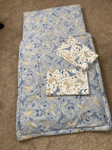 Reviewer's Seaside Charm Cotton Poplin fabric crafted into a blue patterned quilt and bedding set.