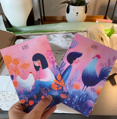 Customer's Gallo&Gallina art prints featuring stylized illustrations of a person with a hen and a person with a rooster.