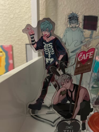 Customer's Alien Stage acrylic standee displayed on a shelf with other character figures.