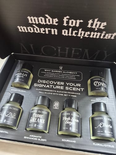 Customer's open Discovery Set box, showcasing six small fragrance oil bottles arranged in a black interior tray.