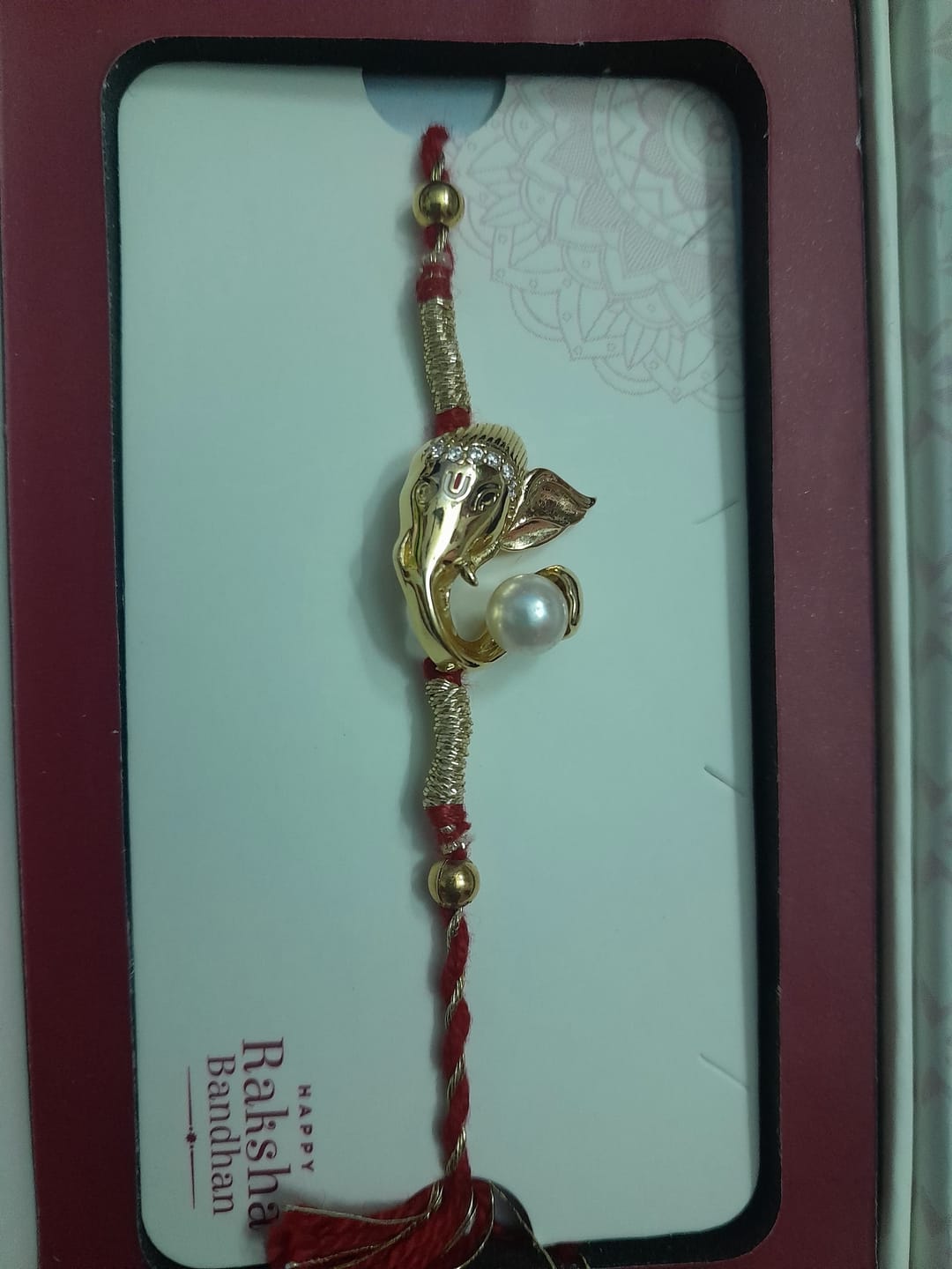 Customer photo review of Golden Iconic Ganesha Rakhi