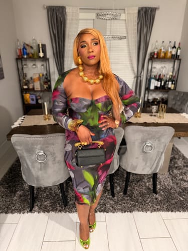 Reviewer's Mesh Print Midi Dress featuring floral print and corset bodice, standing in a decorated home.