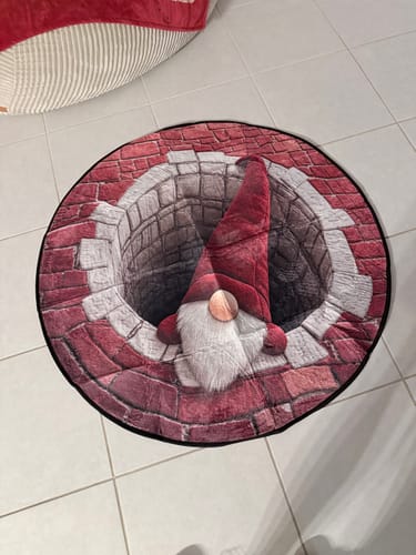 Customer's round Christmas 3D Vortex optical illusion rug featuring a gnome design, placed on a tiled floor.