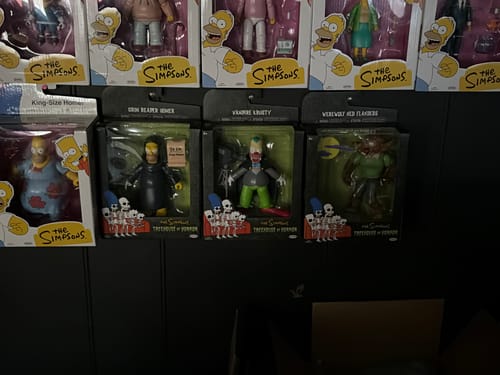 Customer's Werewolf Ned Flanders The Simpsons action figure in original packaging displayed on a shelf with other figures.