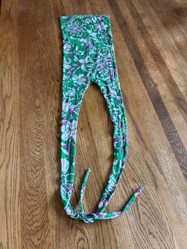 Customer's Blossom Splash Viscose Jersey Fabric fashioned into a green floral head cover on a wooden surface.