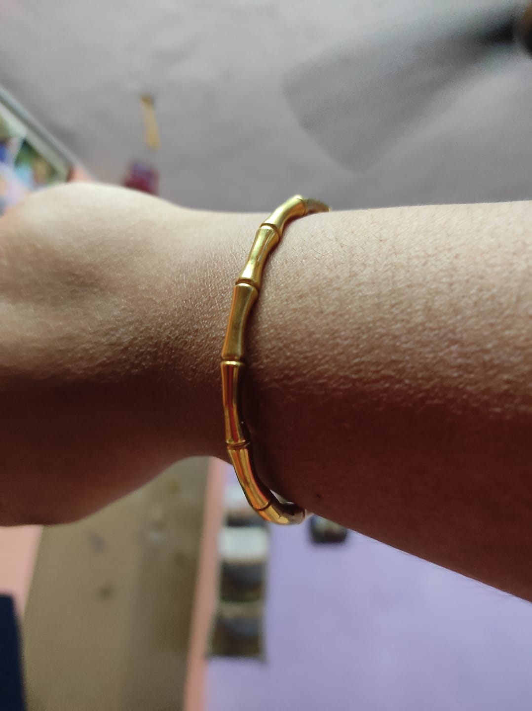 Customer photo review of Sleek Golden Round Bangle Bracelet