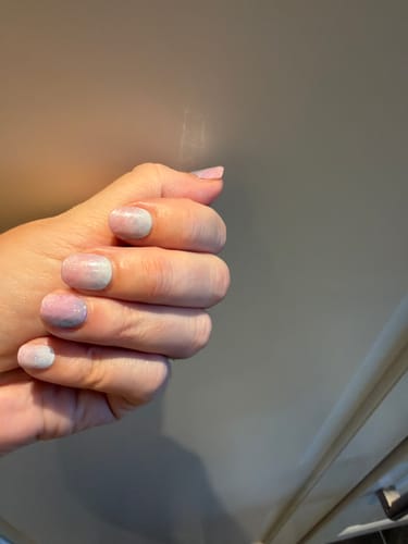 Customer's hand wearing Mix & Match Refill Bundle nail strips, showing pink and blue gradient after 6 days of wear.