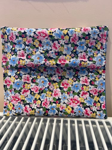 Reviewer's snack pouch made from floral Tiny Blooms cotton poplin fabric with a navy background