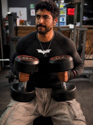 Customer's Batman Compression Longsleeves worn while lifting black dumbbells in a gym setting.
